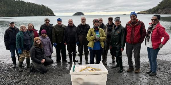 Volunteer appreciation celebration at Bowman Bay with members of Skagit MRC and Salish Sea Alliance, honoring volunteers who’ve supported MRC work for over a decade. The tub in front holds the beach seining gear managed by Paul Dinnel, a Skagit MRC member who’s been part of the beach seining effort since day one! (Lisa Kaufman).