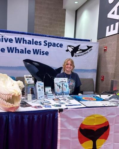 MRC Youth Representative Lola Walker helped pass out whale warning flags at the Be Whale Wise booth at the Seattle Boat Show. (Alex Borowincz).