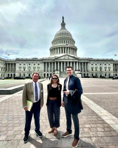 three people in front of the Capitol DC