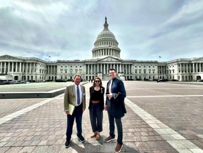 Three people in front of the Capitol, DC.