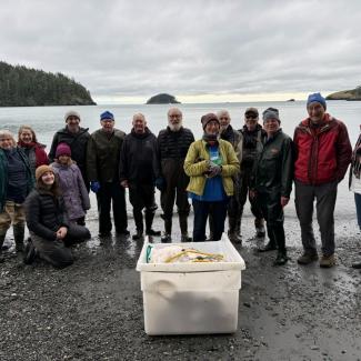 Volunteer appreciation celebration at Bowman Bay with members of Skagit MRC and Salish Sea Alliance, honoring volunteers who’ve supported MRC work for over a decade. The tub in front holds the beach seining gear managed by Paul Dinnel, a Skagit MRC member who’s been part of the beach seining effort since day one! (Lisa Kaufman).